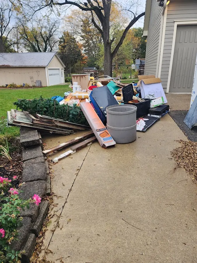 Dumpster being loaded with debris for 30 Yard Dumpster Rental in Lumberton